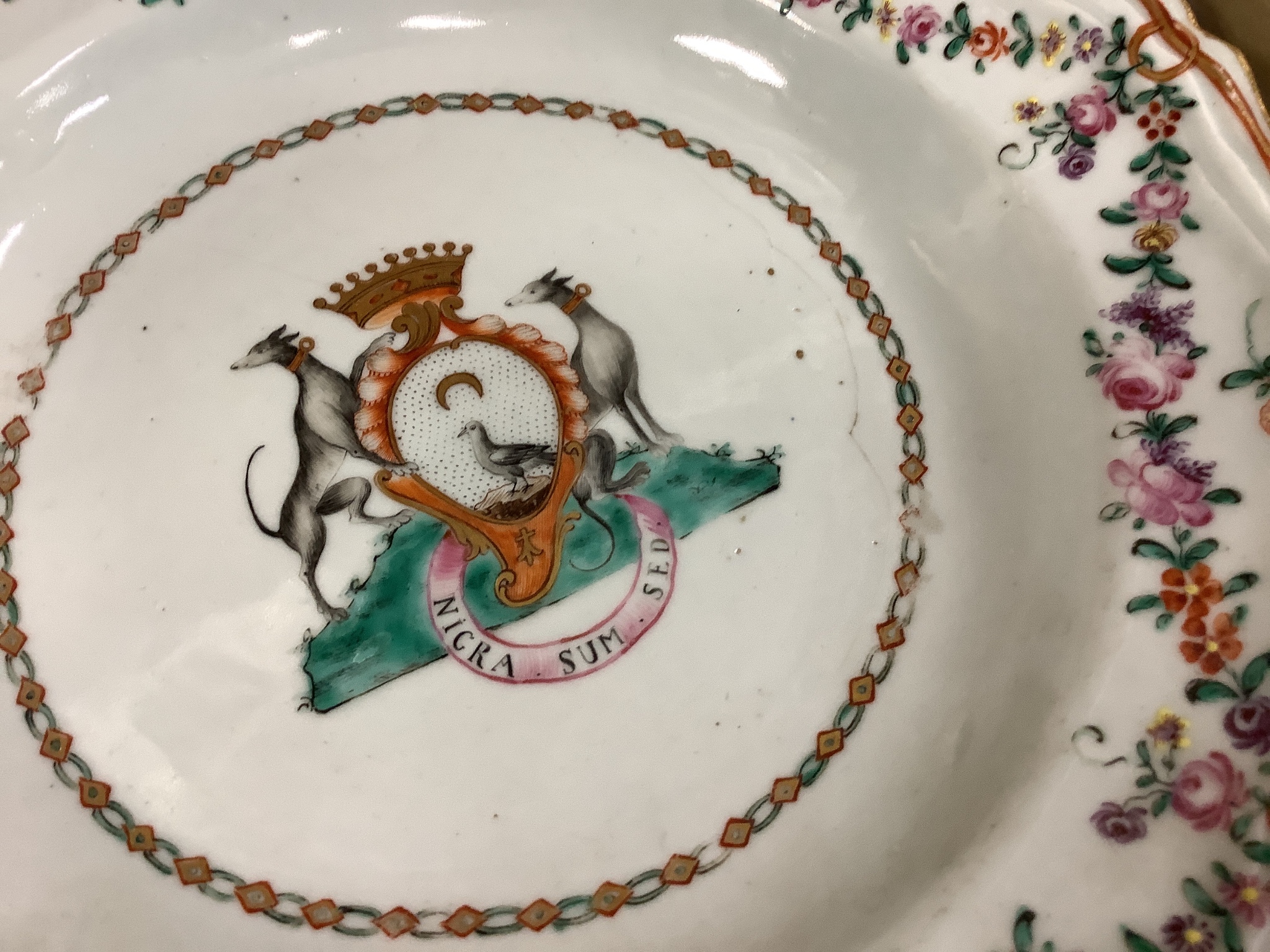 A Chinese export armorial soup plate, a large 18th century Chinese export porcelain footed punch bowl on stand, A Chinese blue and white plates and a pearlware plate